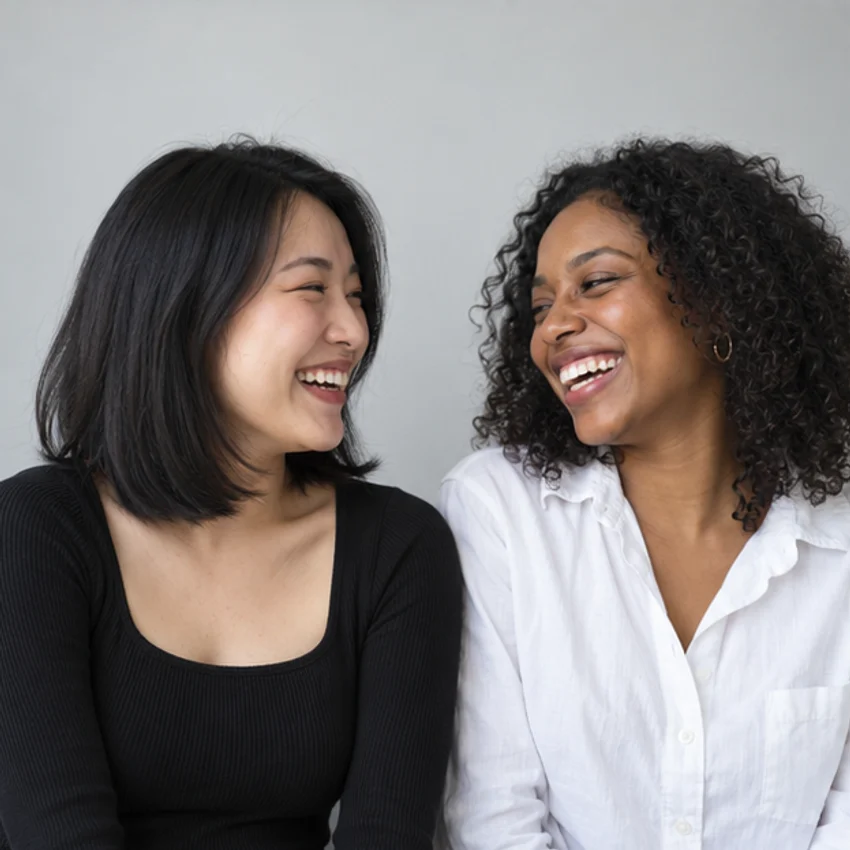 Two friends laughing between poses