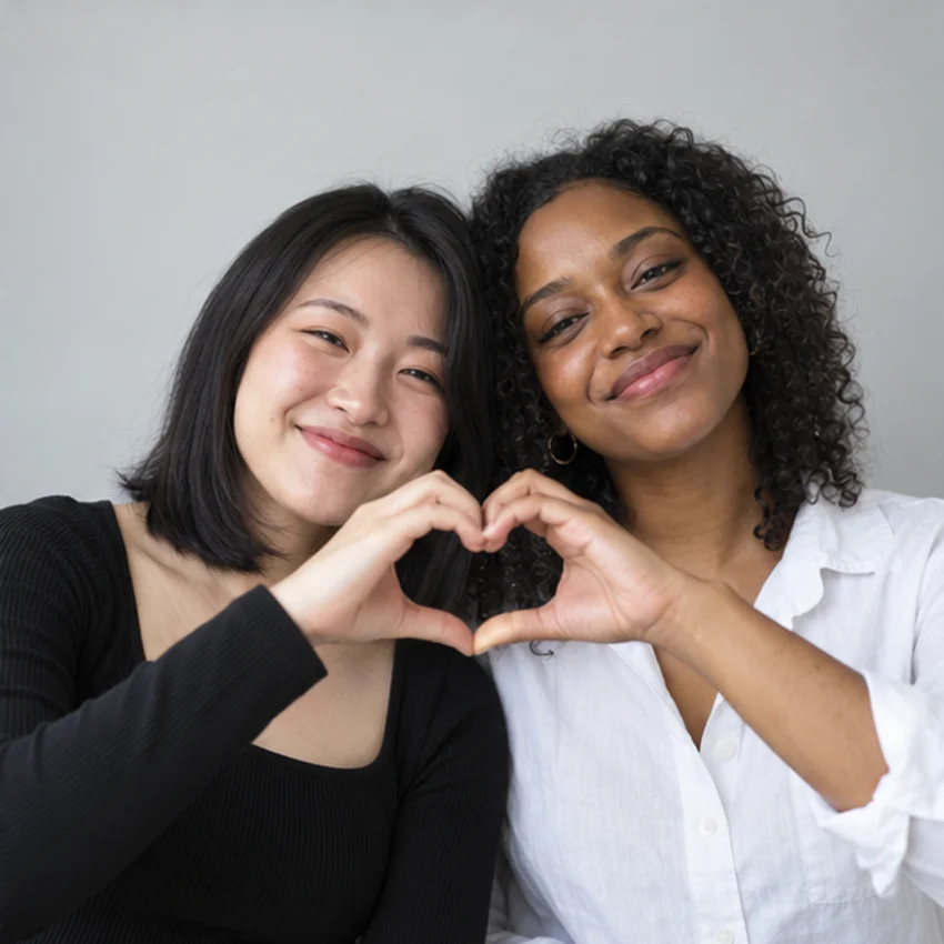 A little heart: two friends in a monochrome photo booth portrait